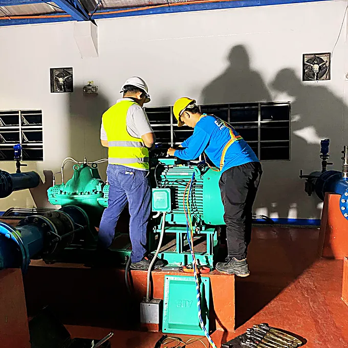 Bestcor technicians servicing a pump and motor set in a plant room.
