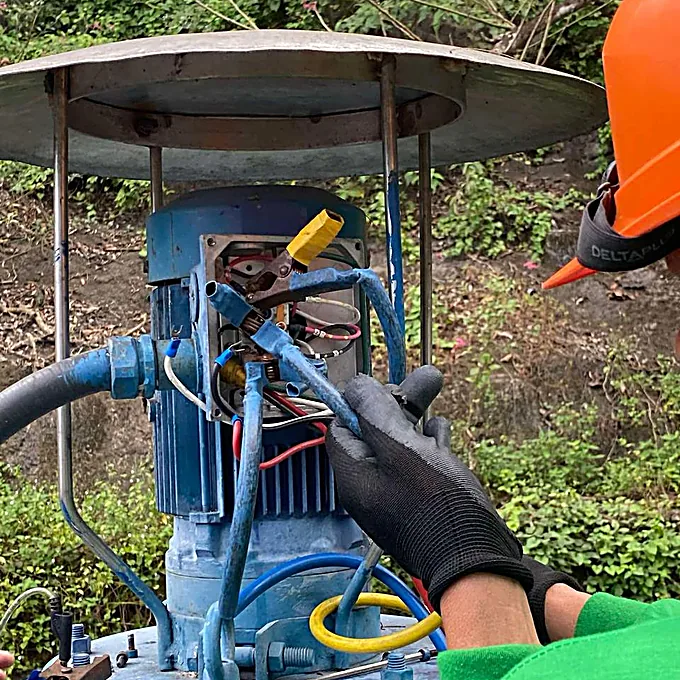 Bestcor technician working on electrical and pump equipment.